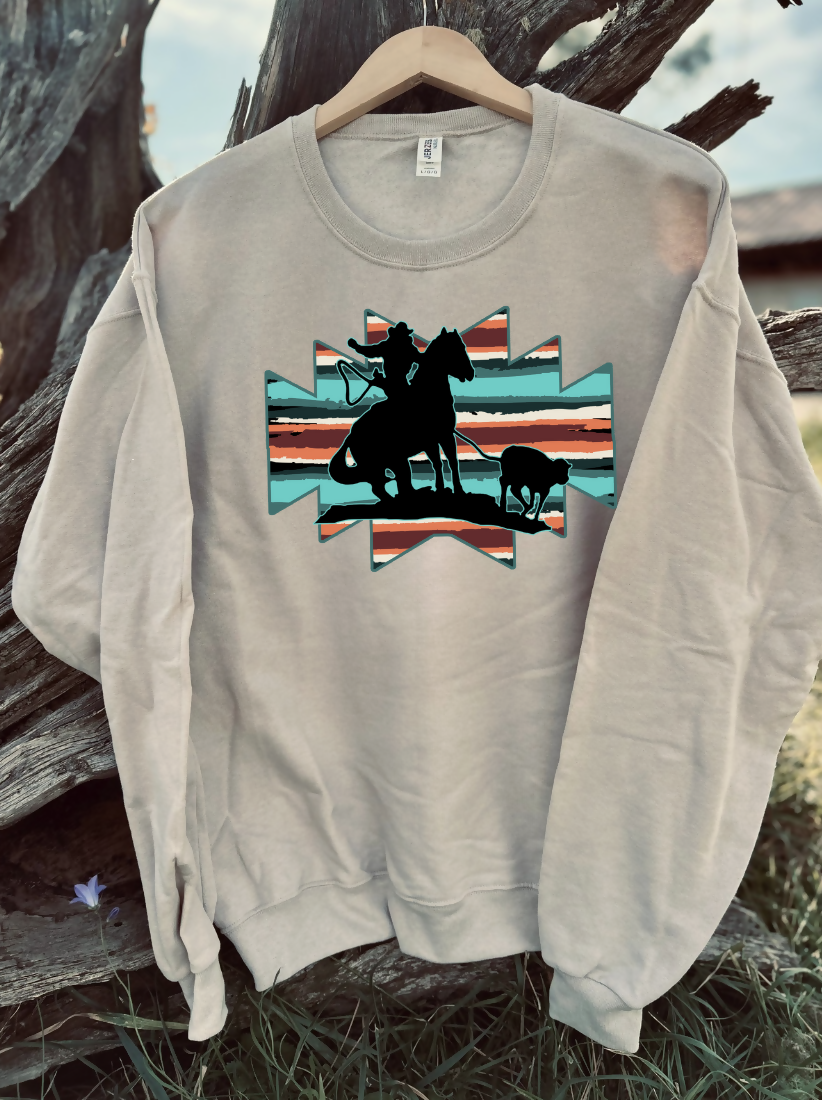tan sweatshirt with a design on a wooden background