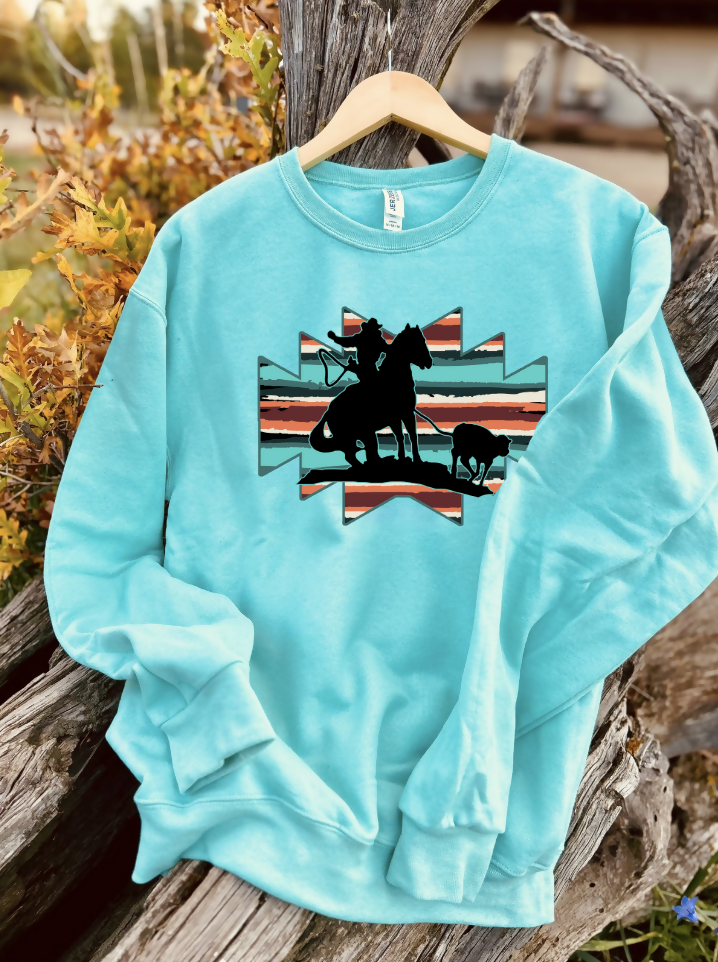 mint sweatshirt with a design on a wooden background
