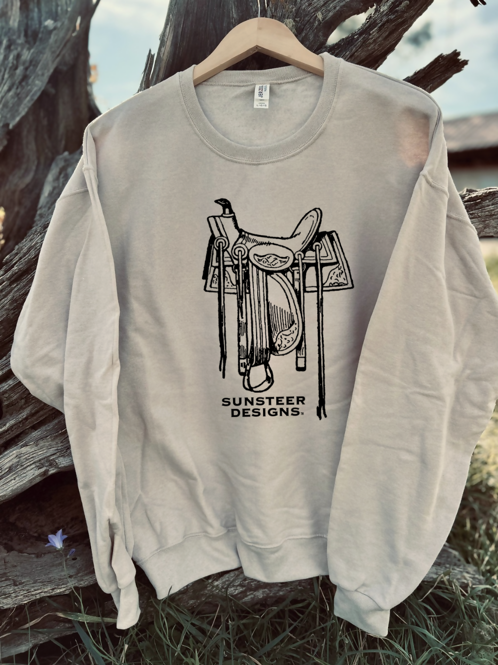 tan sweatshirt with a design on a wooden background