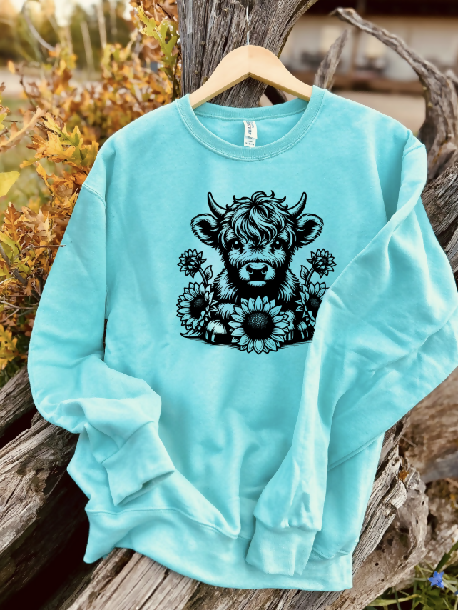 mint sweatshirt with a design on a wooden background