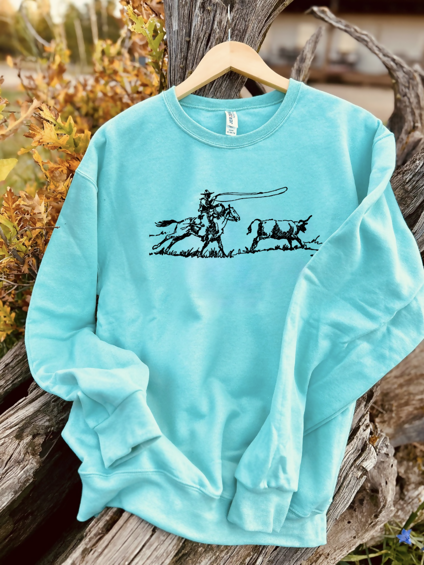 mint sweatshirt with a design on a wooden background