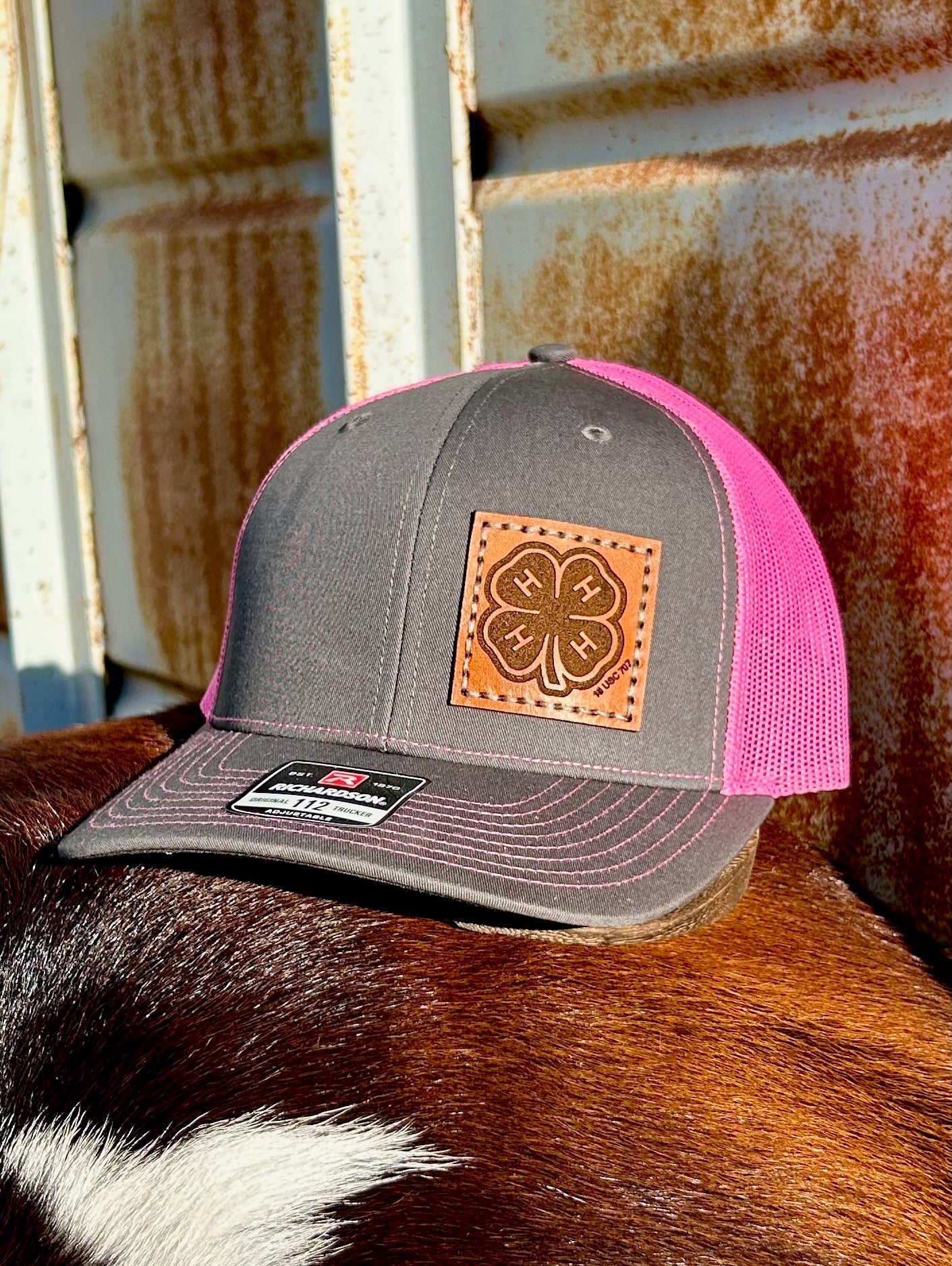 Gray and pink cap with a leather patch on a cow's back