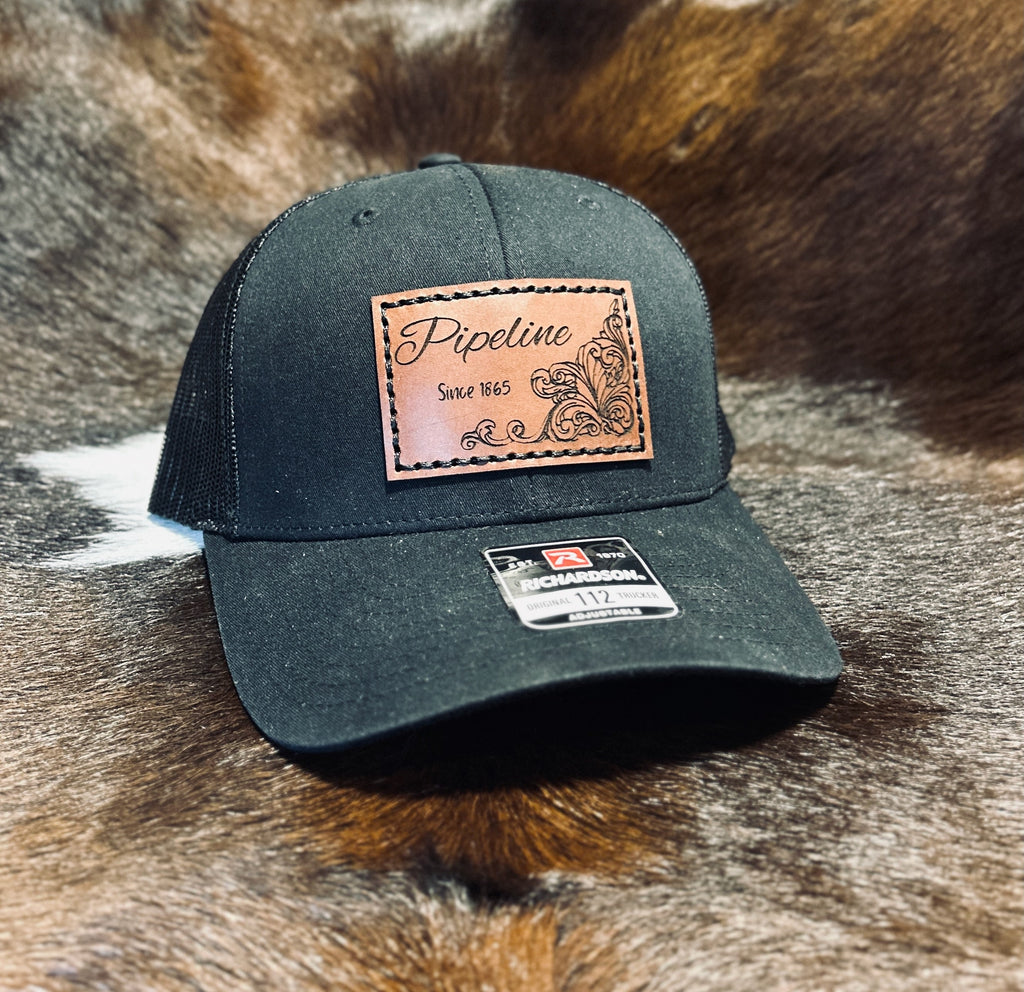 Dark green cap with leather patch on a fur background