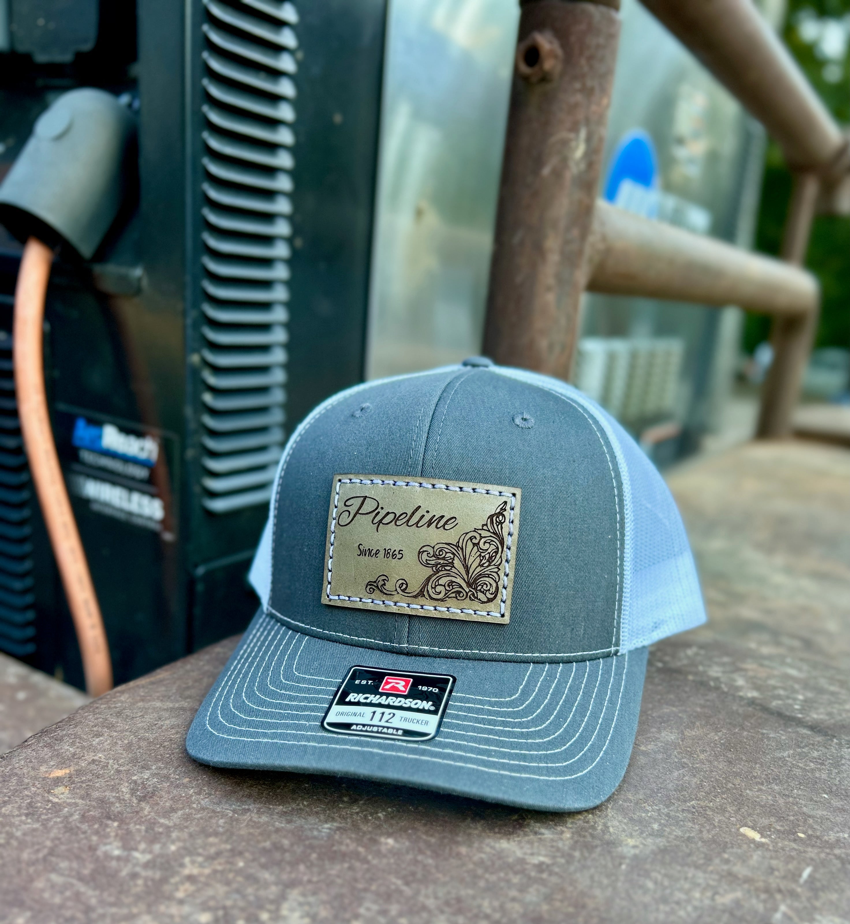 Gray cap with a logo on a wooden surface