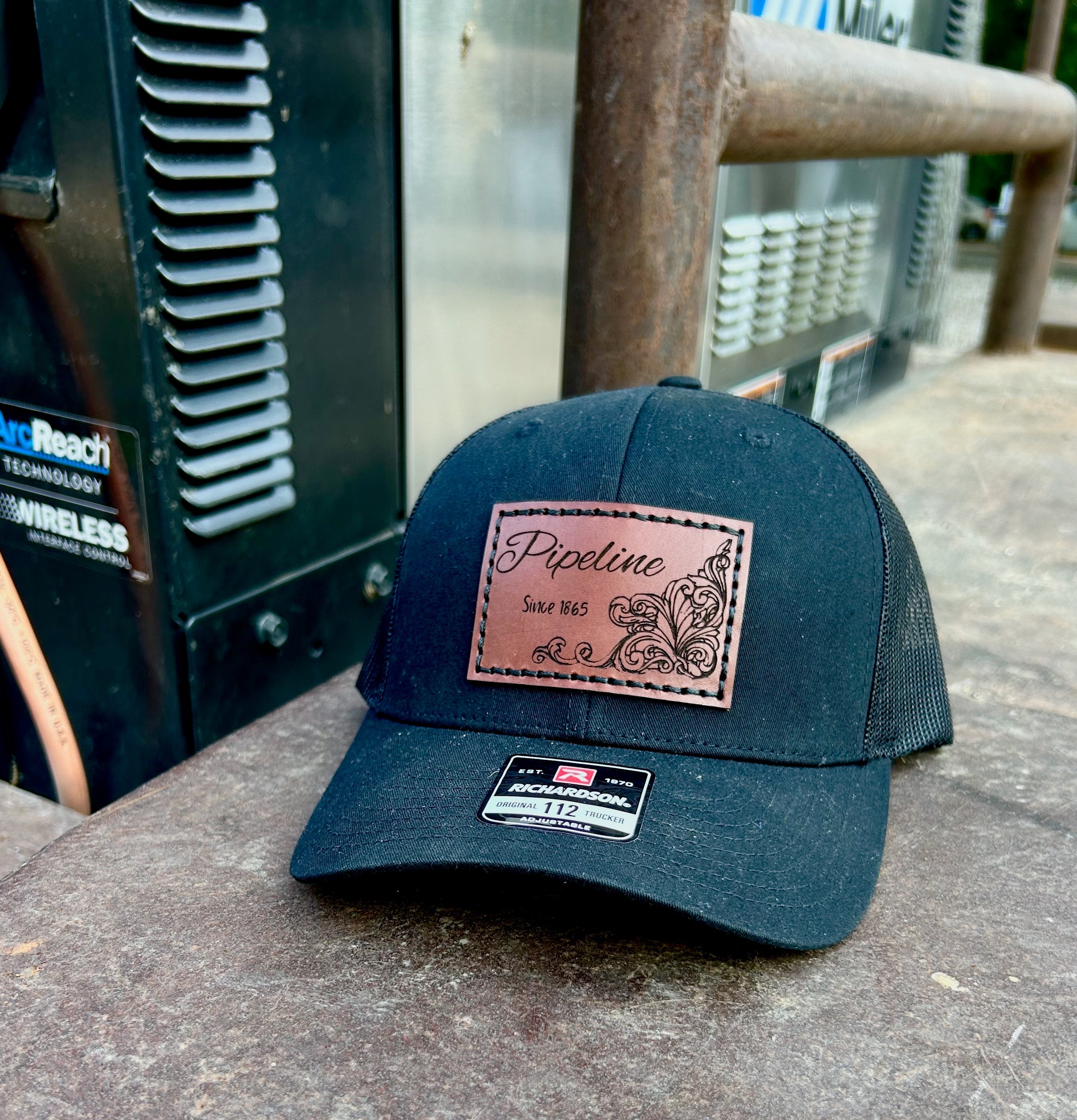 Blue cap with a leather patch on a concrete surface