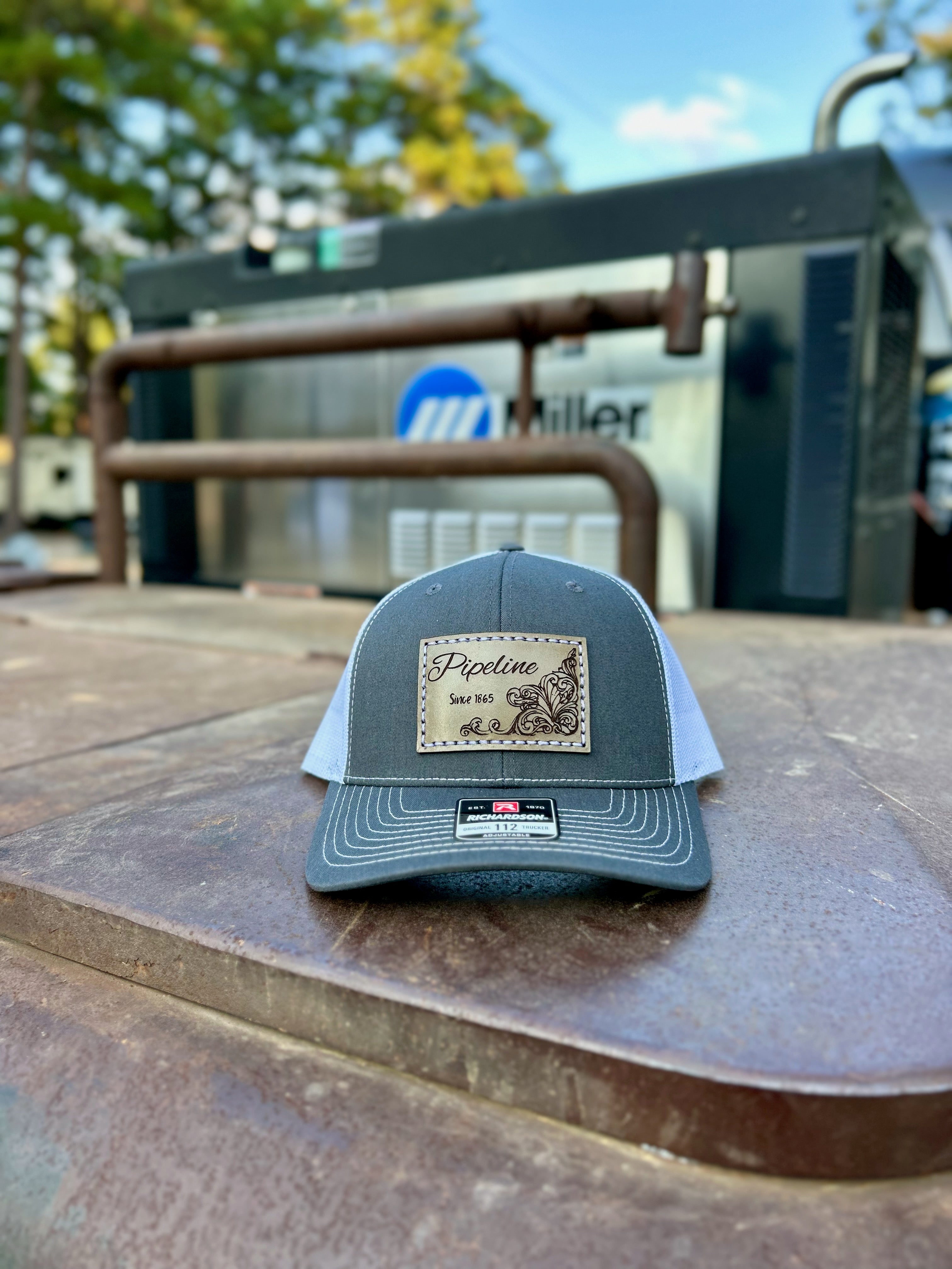 Gray cap with a patch on a metal surface with a blurred background