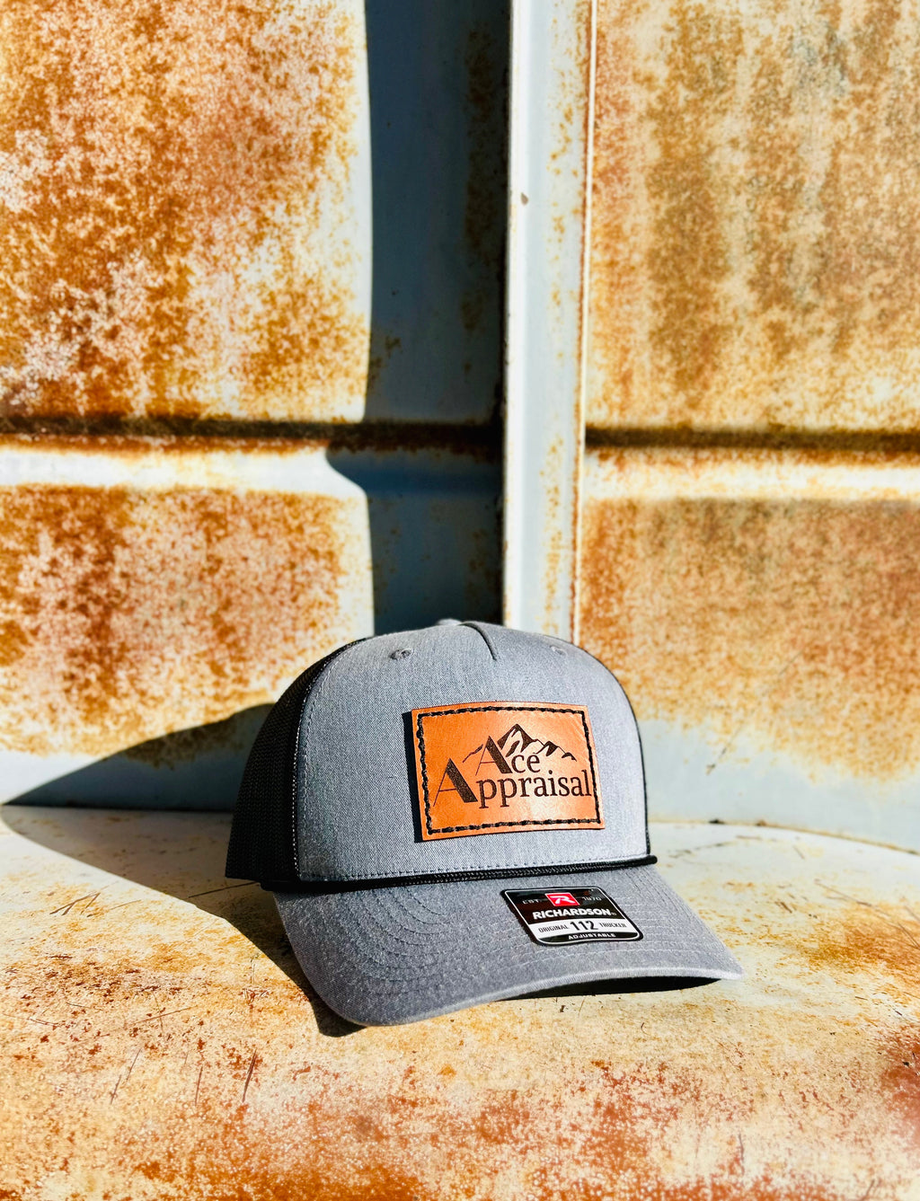 Gray cap with leather patch on a rusty metal surface