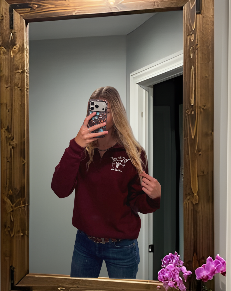 Person taking a mirror selfie with a wooden-framed mirror in a bathroom.
