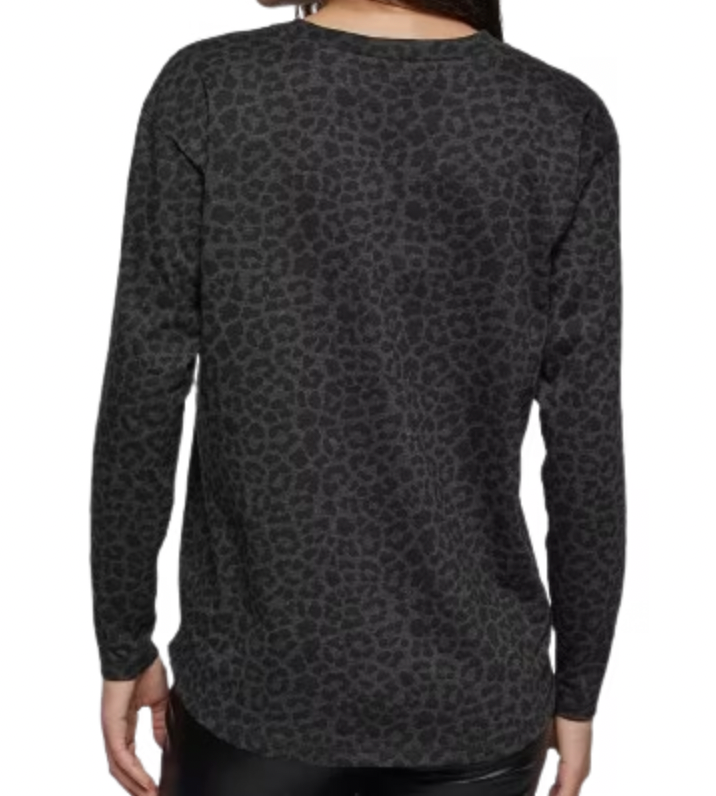 Black long-sleeve shirt with a subtle pattern worn by a person on a white background