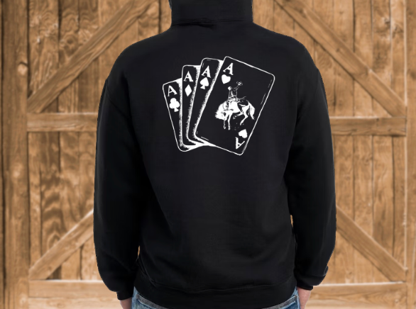 Black hoodie with playing card design on the back against a wooden background