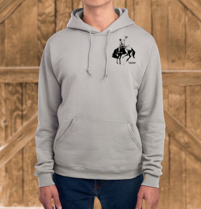 Person wearing a gray hoodie with a graphic design on a wooden background