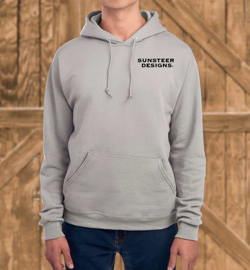Person wearing a gray hoodie with 'Sunsteer Designs' logo against a wooden background