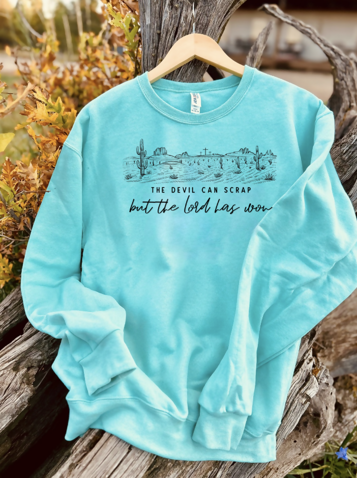 mint sweatshirt with a design on a wooden background