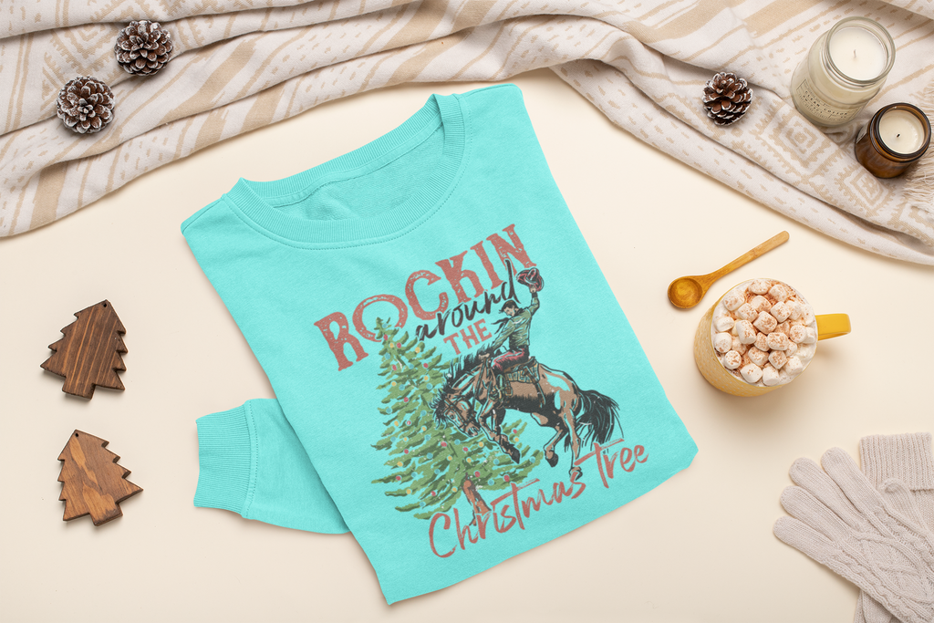 Mint sweatshirt with Christmas design on a light surface with decorative items.