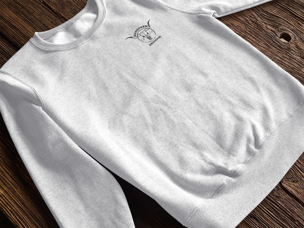 White sweatshirt with a logo on a wooden surface