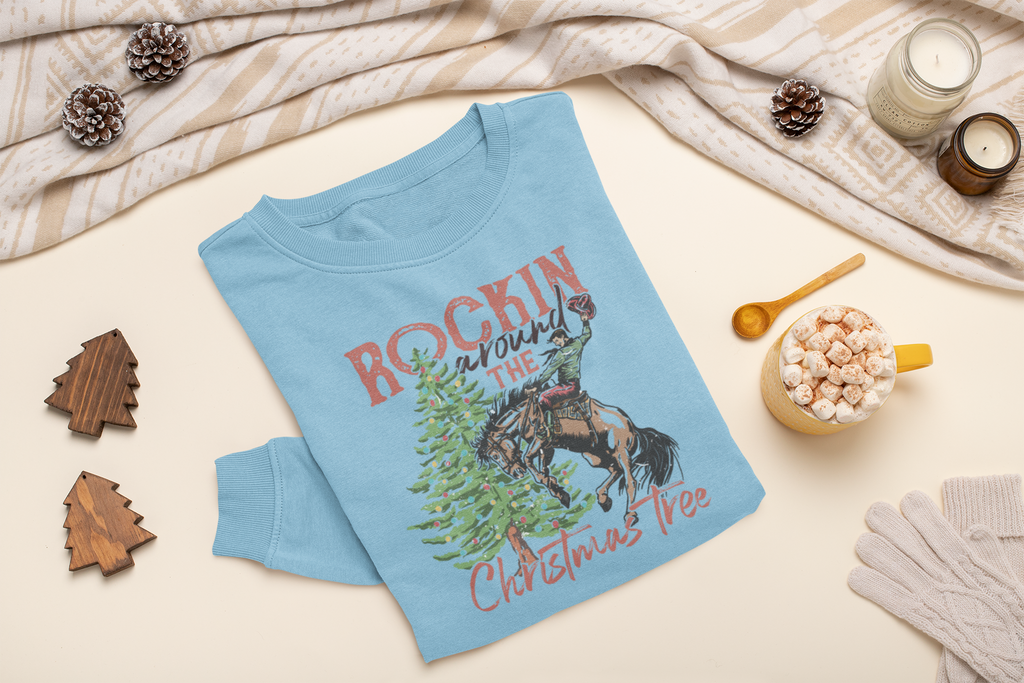 Light blue t-shirt with horse and Christmas tree design on a neutral background