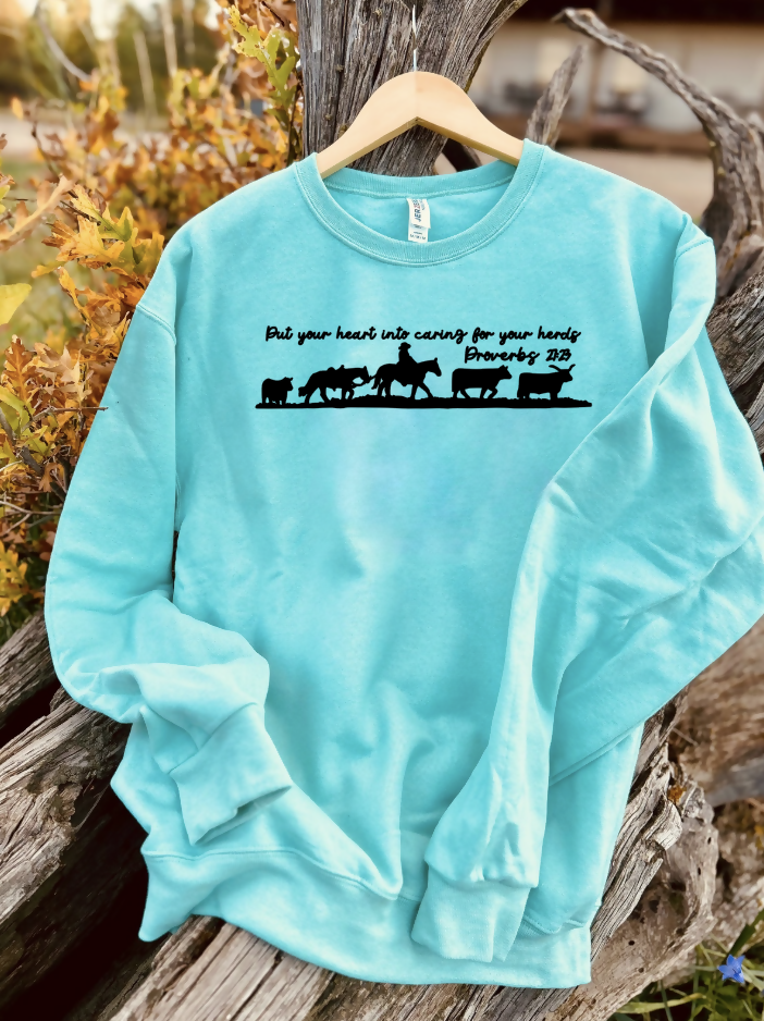 mint sweatshirt with a design on a wooden background