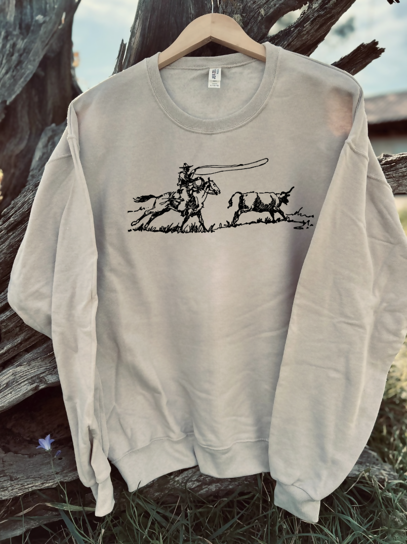 tan sweatshirt with a design on a wooden background