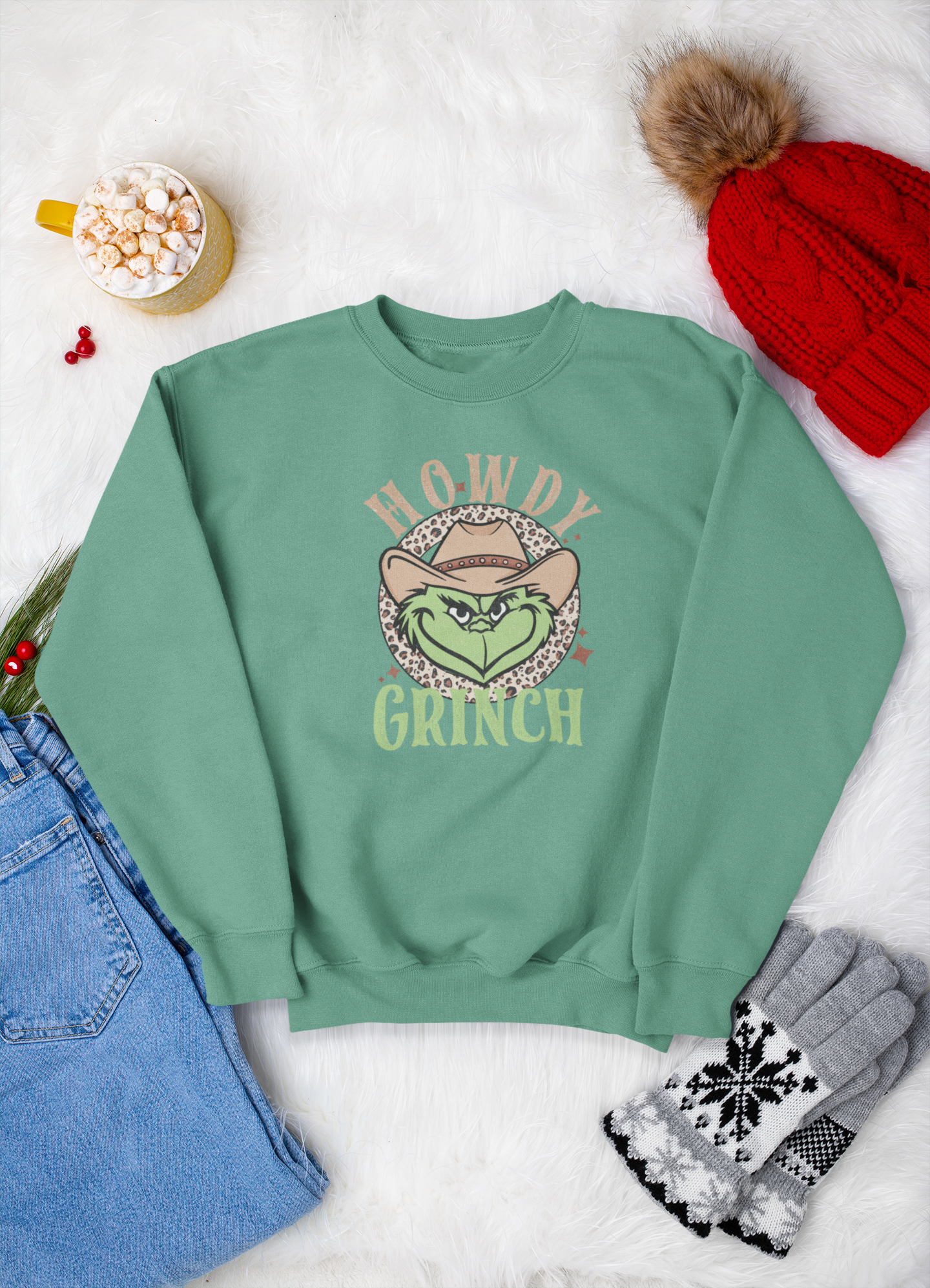 Green sweatshirt with 'Howdy Grinch' graphic on a white background with festive items.