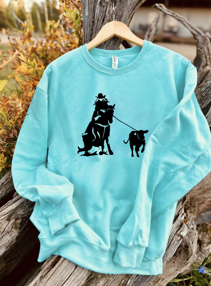 mint sweatshirt with a design on a wooden background